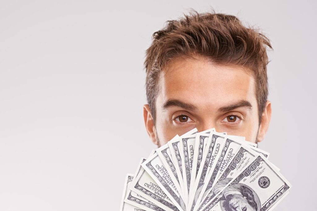 man holding money above face face